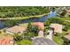 Aerial view of beautiful home features mature trees, a long driveway, and water views at 7231 Brambury Ct, Sarasota, FL 34238