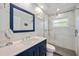 Modern bathroom featuring a glass shower door, a sink with vanity, and bright lighting at 7231 Brambury Ct, Sarasota, FL 34238