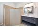 Bathroom featuring tiled shower, granite countertop on vanity, and built-in lighting at 7231 Brambury Ct, Sarasota, FL 34238