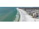 Aerial view of the beach with clear turquoise water and high rise buildings in the background at 7231 Brambury Ct, Sarasota, FL 34238