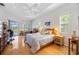 Bright and airy bedroom with a ceiling fan, two windows, hardwood floors, and plenty of space at 7231 Brambury Ct, Sarasota, FL 34238