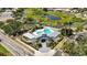 Community clubhouse with a pool, well-maintained landscaping, and a gated entrance at 7231 Brambury Ct, Sarasota, FL 34238