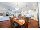 Open floor plan kitchen, dining and living room with hardwood floors and white walls at 7231 Brambury Ct, Sarasota, FL 34238