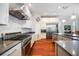 Bright kitchen features stainless steel appliances, gas range, custom cabinets, and a center island with barstool seating at 7231 Brambury Ct, Sarasota, FL 34238