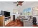 Cozy room with hardwood floors, TV, and large window with plantation shutters at 7231 Brambury Ct, Sarasota, FL 34238