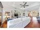 Bright living room with tray ceiling, hardwood floors and built-in shelving at 7231 Brambury Ct, Sarasota, FL 34238
