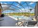 Relaxing screened in pool area with lakeside views and ample space for outdoor entertaining at 7231 Brambury Ct, Sarasota, FL 34238