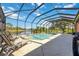 Enclosed pool area features a brick trimmed pool overlooking a peaceful lake setting in this home at 7231 Brambury Ct, Sarasota, FL 34238