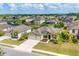 Aerial view of a home with a 3-car garage, manicured lawn, and beautiful landscaping at 7418 61St E St, Palmetto, FL 34221