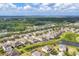 A neighborhood with houses having swimming pools and green lawns along a pond at 7418 61St E St, Palmetto, FL 34221