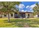 Spacious screened patio with seating, a grill, and a fire pit, all set on a well-kept lawn at 7418 61St E St, Palmetto, FL 34221
