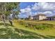 Spacious backyard with a lush green lawn, pond view, and iron fence at 7418 61St E St, Palmetto, FL 34221