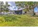Home's backyard featuring a lawn and screened patio area with a firepit at 7418 61St E St, Palmetto, FL 34221