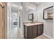 This bathroom features double sinks, wood-look tile flooring, and access to the shower and bedroom at 7418 61St E St, Palmetto, FL 34221