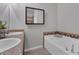This bathroom features double sinks, a large tub, and tiled accents on the tub surround at 7418 61St E St, Palmetto, FL 34221