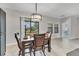 Dining room features hardwood floors, leather chairs, a modern chandelier and view to the backyard at 7418 61St E St, Palmetto, FL 34221