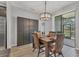 This dining room features hardwood floors, a modern chandelier, and glass doors to the patio at 7418 61St E St, Palmetto, FL 34221