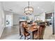 Dining room features hardwood floors, leather chairs, a modern chandelier and open access to the kitchen at 7418 61St E St, Palmetto, FL 34221