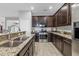 Modern kitchen with dark wood cabinets, stainless steel appliances, and granite countertops at 7418 61St E St, Palmetto, FL 34221