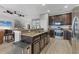 Open kitchen area with a breakfast bar, stainless appliances, and a view into the living room at 7418 61St E St, Palmetto, FL 34221