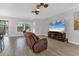 Cozy living room featuring tile floors, a ceiling fan, and a comfortable leather recliner at 7418 61St E St, Palmetto, FL 34221