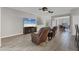 Inviting living room with wood-look tile flooring, comfortable leather chairs, and modern entertainment center at 7418 61St E St, Palmetto, FL 34221