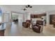 Spacious living room with tile flooring and open layout, adjacent to the dining and kitchen areas at 7418 61St E St, Palmetto, FL 34221