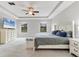 This main bedroom features a decorative tray ceiling, ceiling fan and large windows at 7418 61St E St, Palmetto, FL 34221
