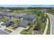 Aerial view of home featuring a manicured lawn, lush landscaping, and a nearby pond at 7743 Nightfall Ter, Sarasota, FL 34241