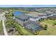 Aerial view of a home with a screened in pool and view of a serene lake at 7743 Nightfall Ter, Sarasota, FL 34241