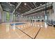 Spacious indoor basketball court with hardwood floors and natural light at 7743 Nightfall Ter, Sarasota, FL 34241
