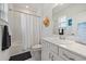 Bathroom featuring a shower-tub combo, vanity with white cabinets, and stylish decor at 7743 Nightfall Ter, Sarasota, FL 34241