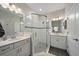 Clean bathroom features a glass shower, double sinks and white cabinetry at 7743 Nightfall Ter, Sarasota, FL 34241