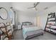Bedroom boasts bright windows, soft carpet, and decoratively styled shelving, creating a cozy sanctuary at 7743 Nightfall Ter, Sarasota, FL 34241