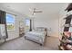 Bright bedroom with plush carpet, ceiling fan, and charming decor creating a serene retreat at 7743 Nightfall Ter, Sarasota, FL 34241