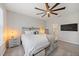 Bright bedroom showcases a ceiling fan, window, queen bed, and a door to the bathroom at 7743 Nightfall Ter, Sarasota, FL 34241