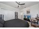 Comfortable bedroom featuring a dark bed set and ceiling fan at 7743 Nightfall Ter, Sarasota, FL 34241