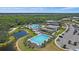 Aerial view of community pools, lounging areas, a lake and tennis courts at 7743 Nightfall Ter, Sarasota, FL 34241