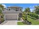 Charming two-story home featuring a two-car garage, manicured landscaping, and a welcoming front entrance at 7743 Nightfall Ter, Sarasota, FL 34241