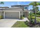 Charming two-story home with a well-maintained lawn, landscaped garden, and neutral color palette at 7743 Nightfall Ter, Sarasota, FL 34241