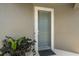 Inviting front door with modern design and a potted plant, creating a warm and welcoming entry at 7743 Nightfall Ter, Sarasota, FL 34241