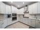 A well-equipped kitchen with stainless steel appliances, white subway tile, and a modern range hood at 7743 Nightfall Ter, Sarasota, FL 34241