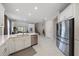 Spacious kitchen with stainless steel appliances, white cabinets, a center island, and an open floor plan at 7743 Nightfall Ter, Sarasota, FL 34241