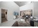 Spacious living room with high ceilings, neutral decor, and an open view to the kitchen and dining area at 7743 Nightfall Ter, Sarasota, FL 34241