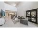 Bright and airy living room showcasing high ceilings and an open layout connecting to the kitchen and dining areas at 7743 Nightfall Ter, Sarasota, FL 34241