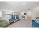 Upstairs loft featuring a cozy sitting area, plush carpet, and views from bright windows at 7743 Nightfall Ter, Sarasota, FL 34241