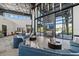 Spacious lounge area featuring modern decor, comfortable seating, fireplace and floor to ceiling windows with beautiful views at 7743 Nightfall Ter, Sarasota, FL 34241