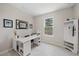 Home office features a large window, light colored floors and a modern white desk at 7743 Nightfall Ter, Sarasota, FL 34241