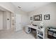 Bright office space with a white desk and gray plank flooring at 7743 Nightfall Ter, Sarasota, FL 34241