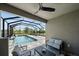 A covered outdoor living space featuring a beautiful pool and screened-in lanai at 7743 Nightfall Ter, Sarasota, FL 34241